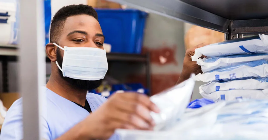 Healthcare worker in mask getting supplies Healthcare worker in mask getting supplies