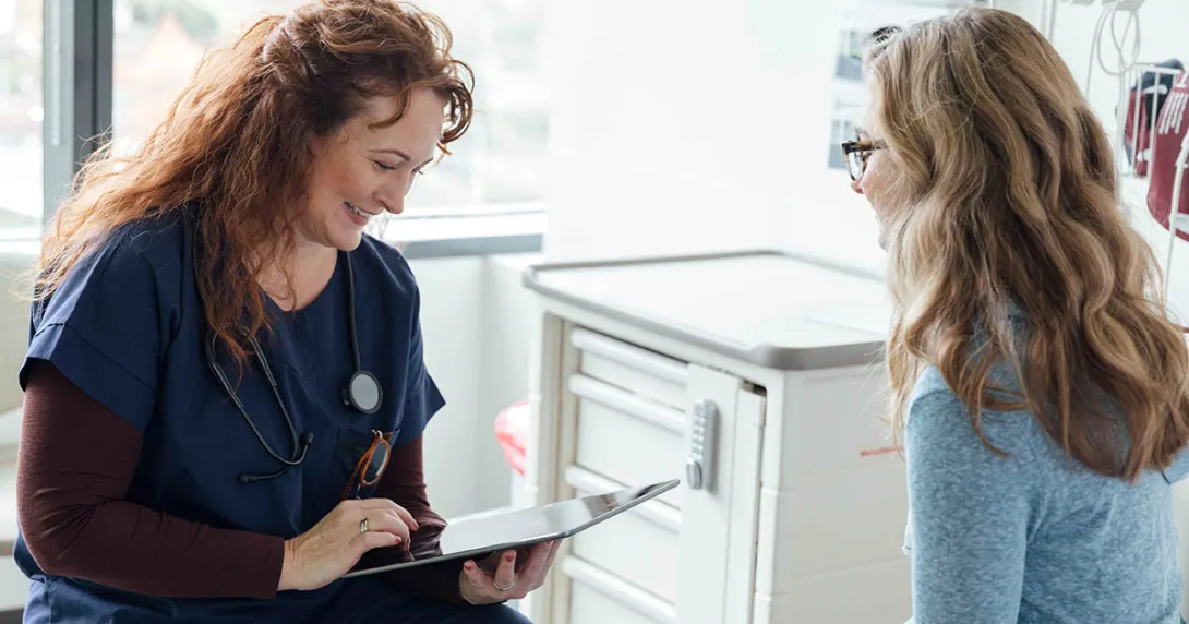 Doctor with tablet talking to patient