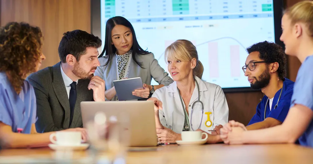 Healthcare workers and business people meeting