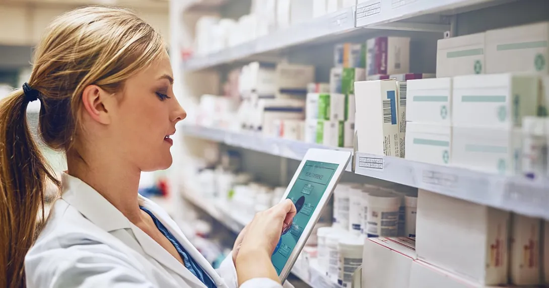 Pharmacist taking inventory with a tablet
