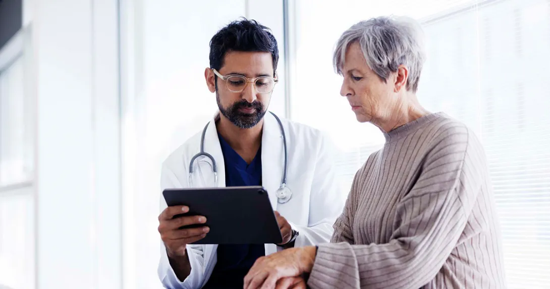 Doctor showing tablet to a patient Doctor showing tablet to a patient