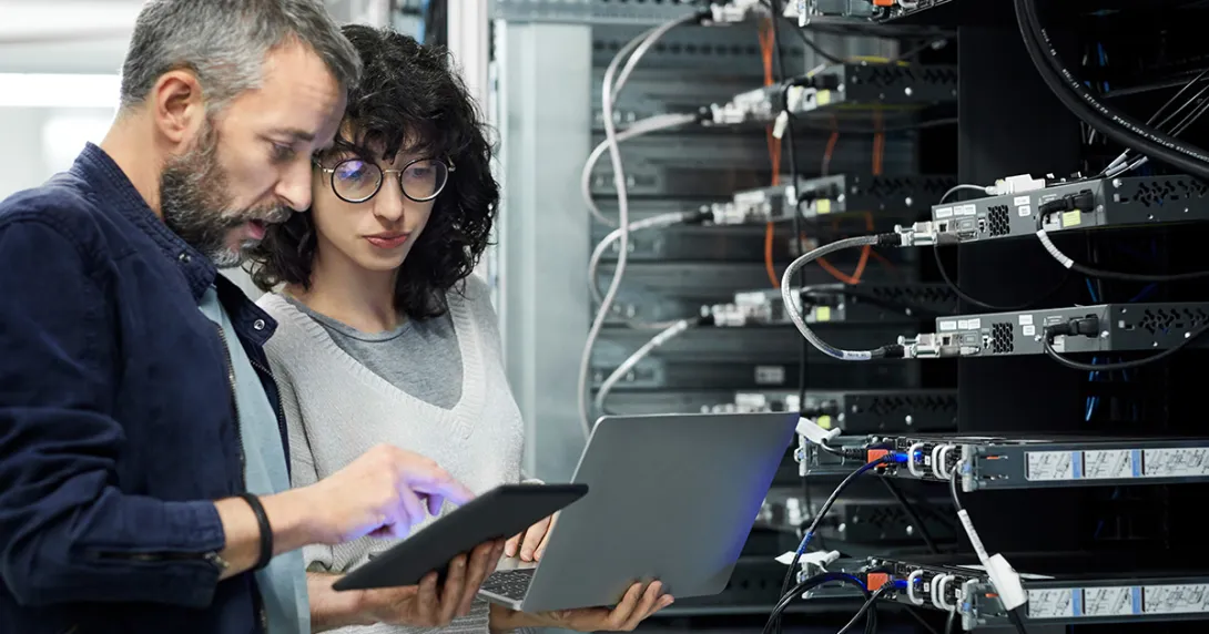 IT and security professionals in a server room IT and security professionals in a server room