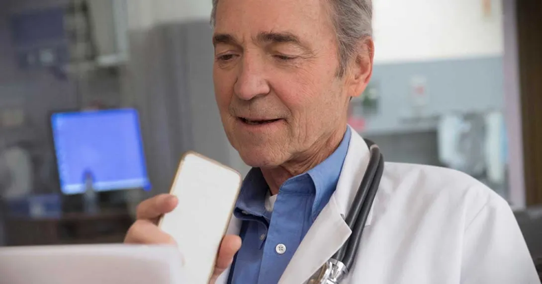 Doctor speaks into a mobile device Doctor speaks into a mobile device