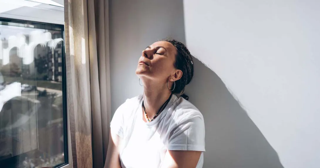 Depressed woman in white shirt leans despairingly against a wall. Depressed woman in white shirt leans despairingly against a wall.