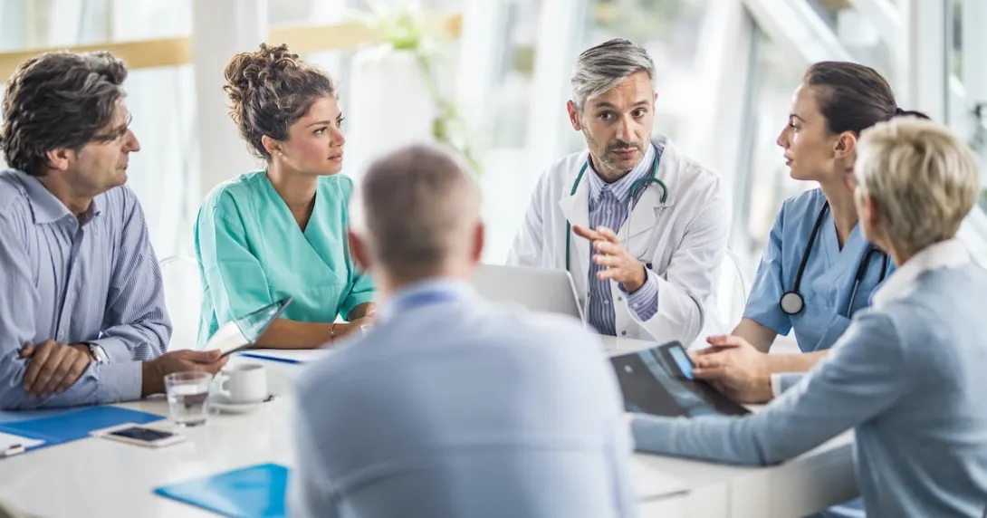 Doctors, nurses and healthcare executives meeting around a table