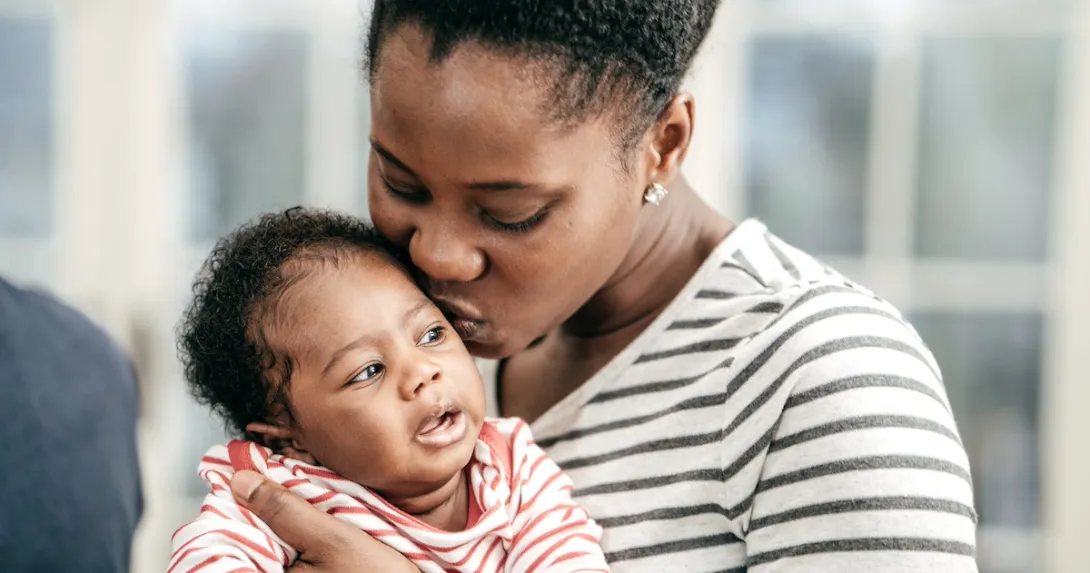 Parent kissing baby