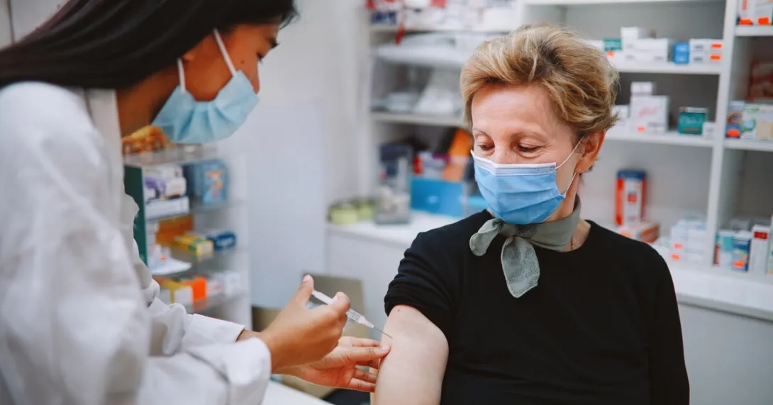 A pharmacist administering a vaccine shot