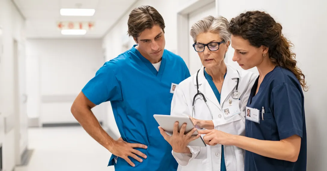 Hospital staff review info on a tablet Hospital staff review info on a tablet