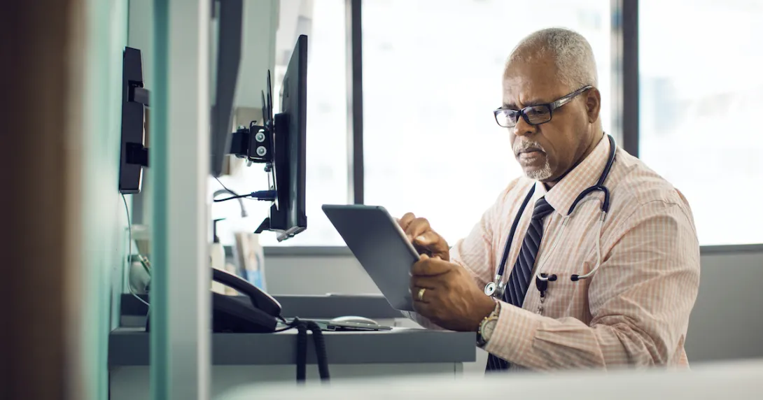 A doctor using a digital tablet