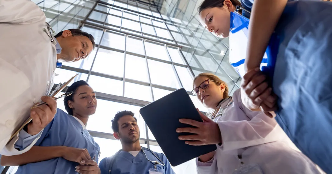 Clinicians reviewing information on a tablet Clinicians reviewing information on a tablet