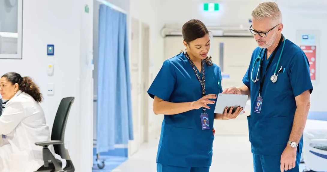 Healthcare workers looking at tablet Healthcare workers looking at tablet
