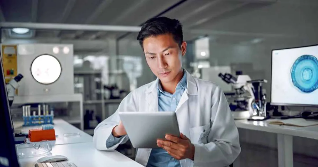 Doctor in lab looking at tablet Doctor in lab looking at tablet