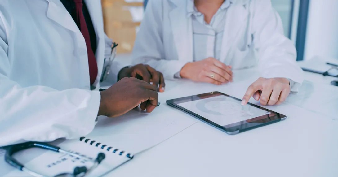 Healthcare workers looking at a tablet