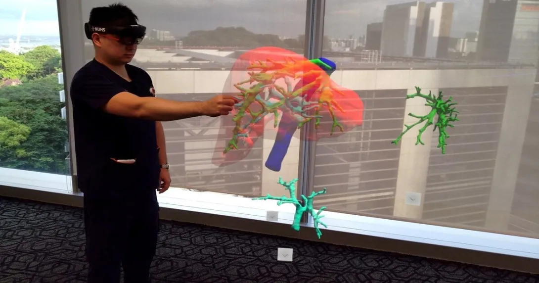 A doctor wearing an MR headset sees and controls a projected 3D hologram of a patient’s liver scan.