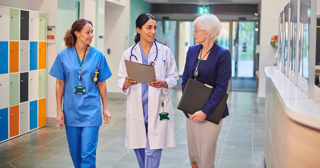 Healthcare workers talking in hallway Healthcare workers talking in hallway