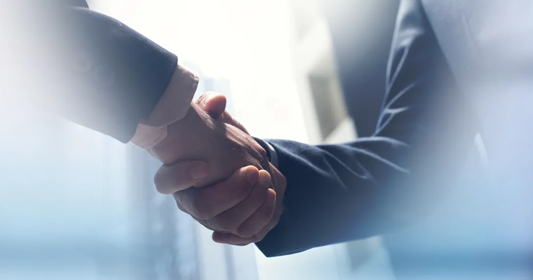 Merger and acquisition handshake Handshake by people in suits