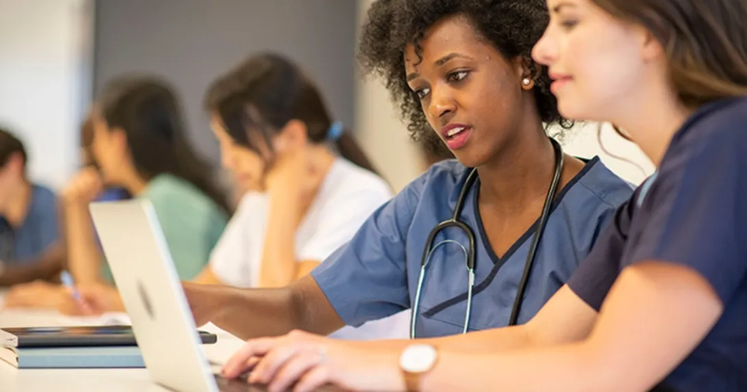 Medical students studying at a computer