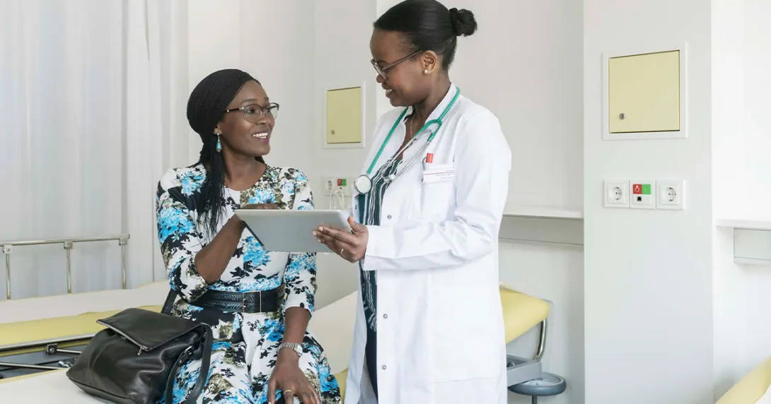 Doctor showing tablet to patient Doctor showing tablet to patient