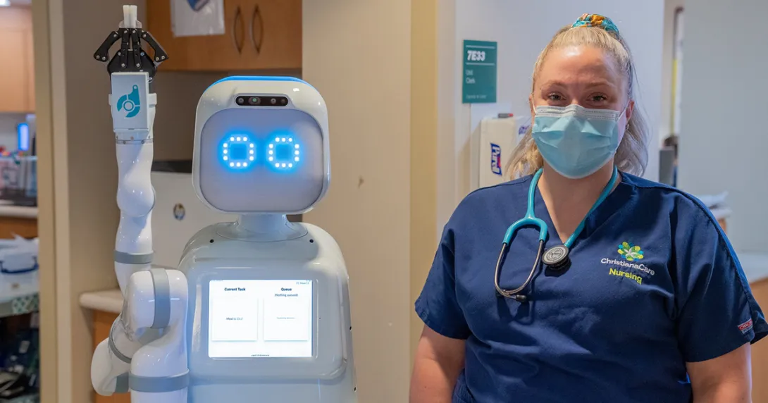 Person in PPE with robot