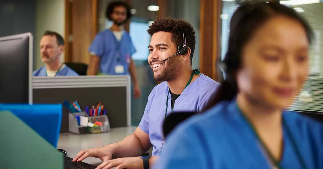 healthcare worker with headset using a computer healthcare worker with headset using a computer