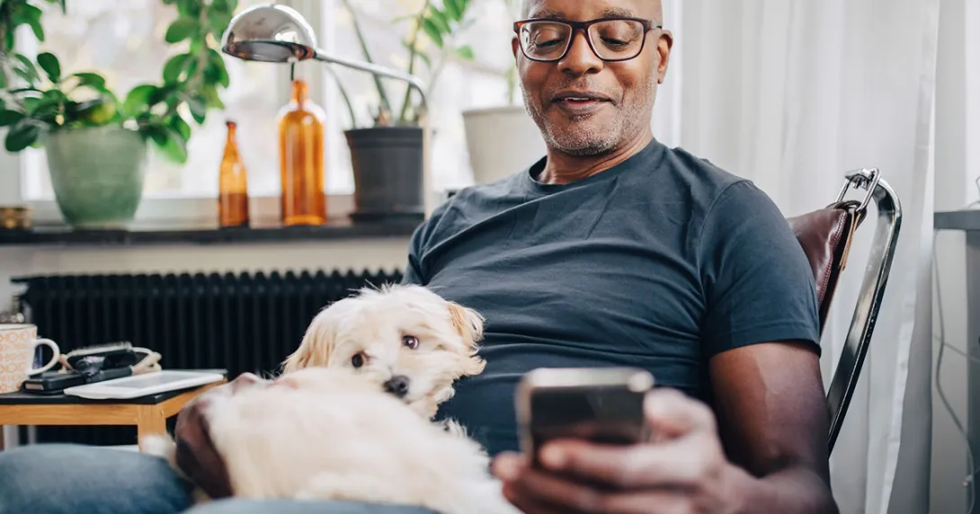 Person with dog using a smartphone