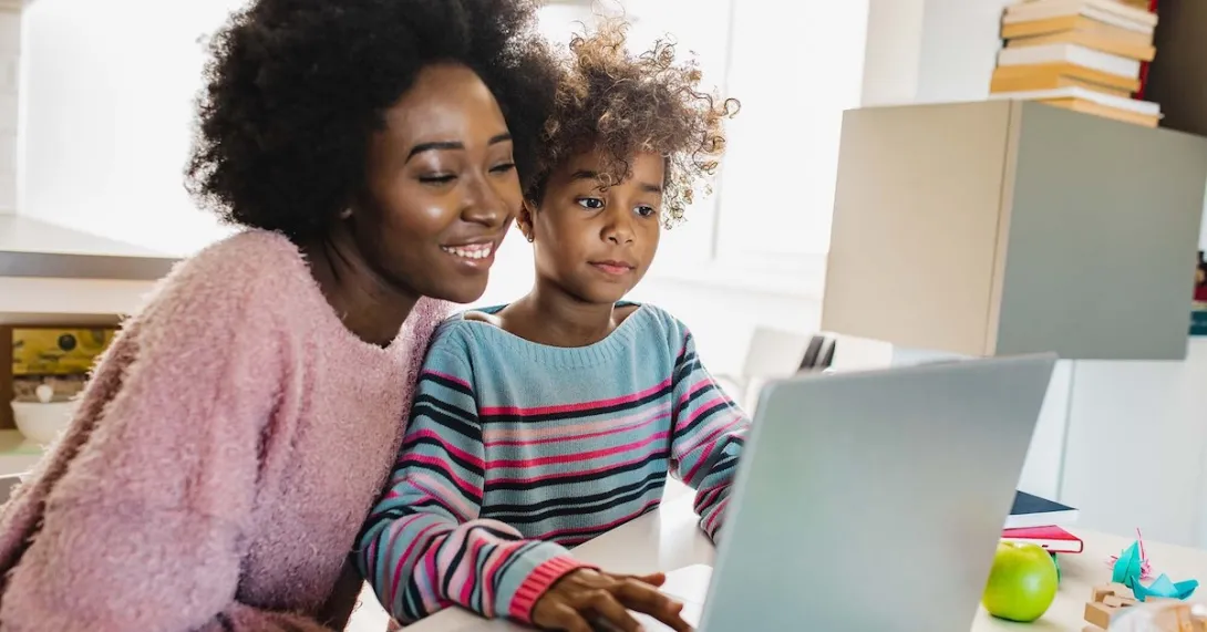 Parent and child using a laptop