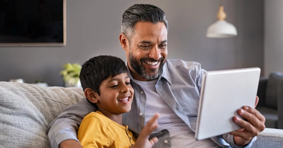 Parent and child looking at tablet Parent and child looking at tablet