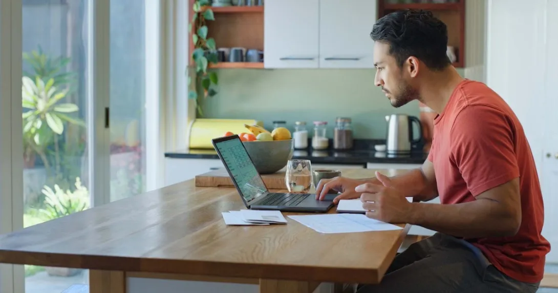 Person using a laptop in a kitchen