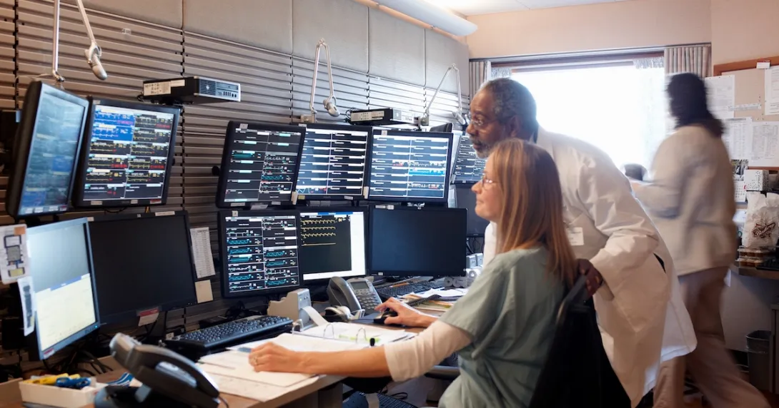Healthcare workers looking at group of monitors