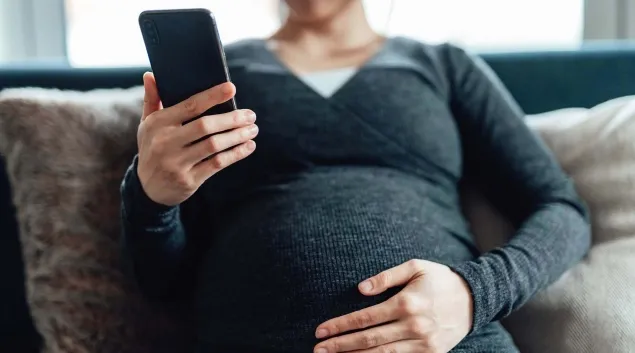 Pregnant person with phone