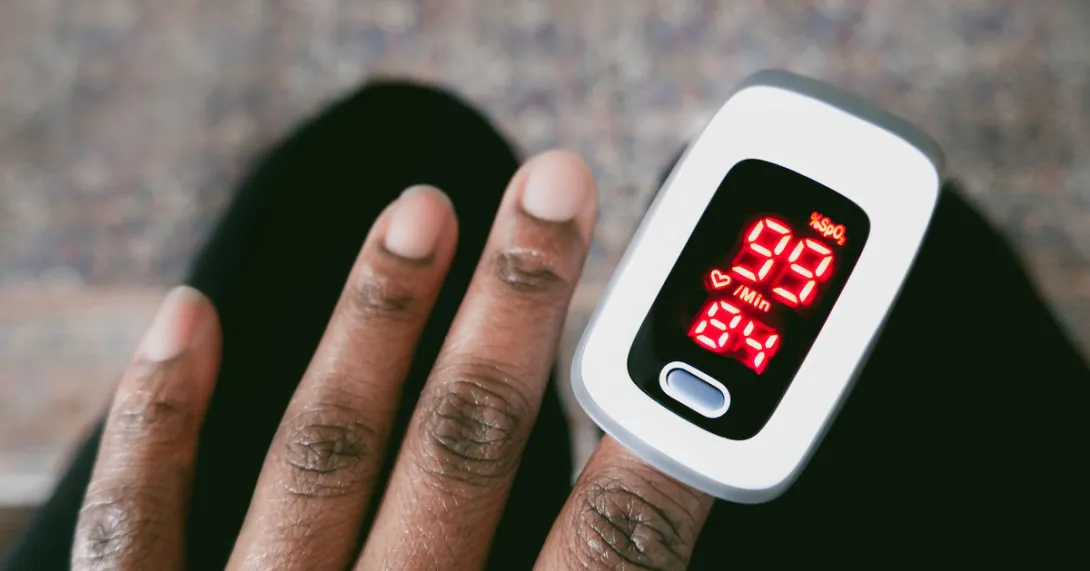 A pulse oximeter device measures oxygen on a hand A pulse oximeter device on a hand