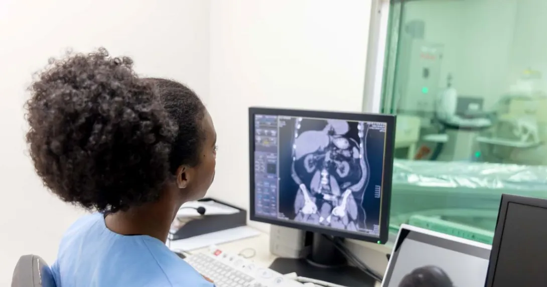 Healthcare worker looking at x-ray image on monitor