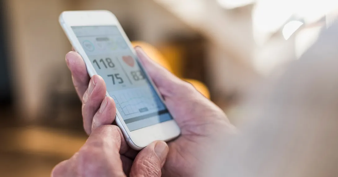 Person using heart rate app on a smartphone Person using heart rate app on a smartphone