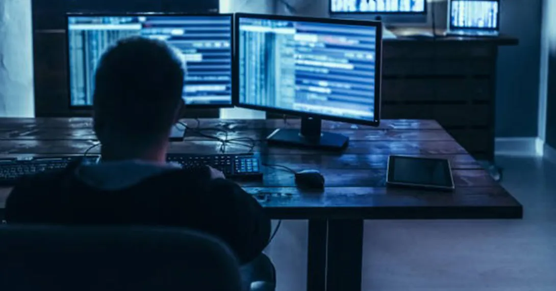 worker looking at dual monitors