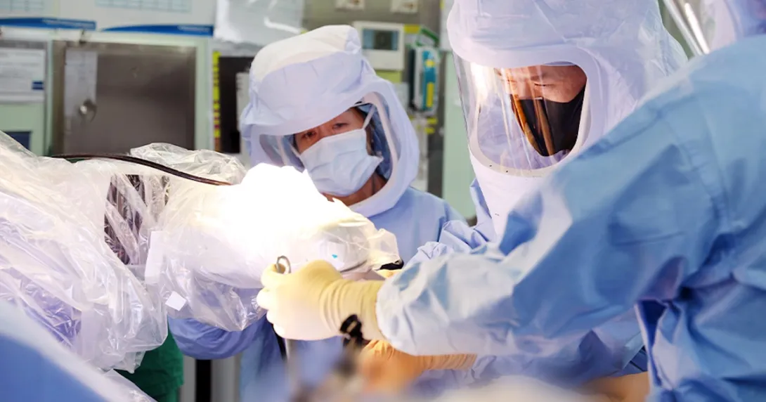 Surgeons operating using robotic technology Surgeons operating using robotic technology