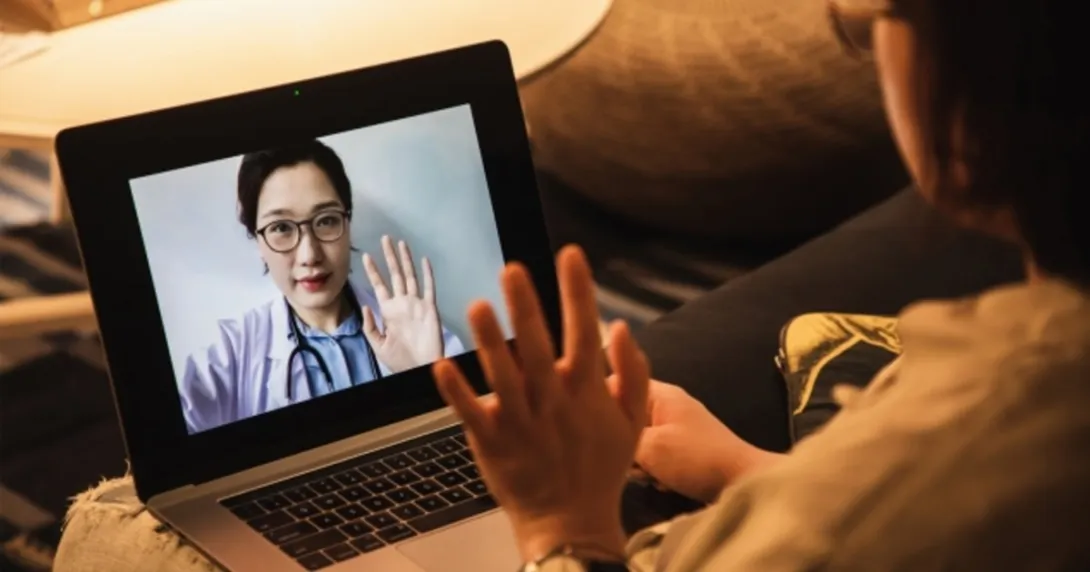 A person looks at a doctor on a screen