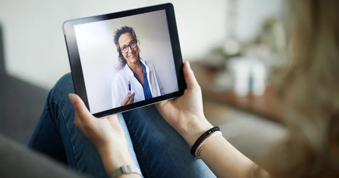 A physician visible on a tablet screen