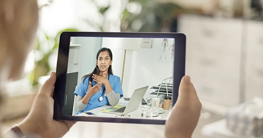 Person consults with person wearing stethoscope via tablet