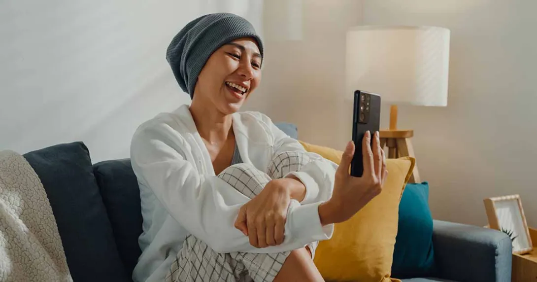 Smiling person looking at a smartphone Smiling person looking at a smartphone