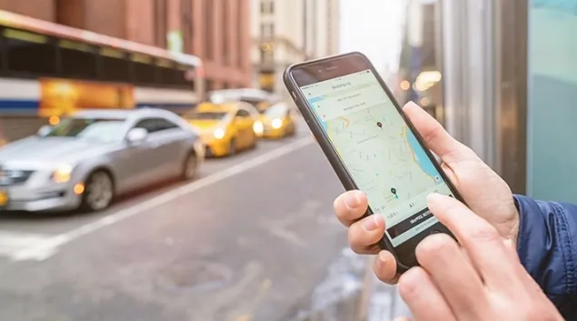 Person using rideshare app on smartphone