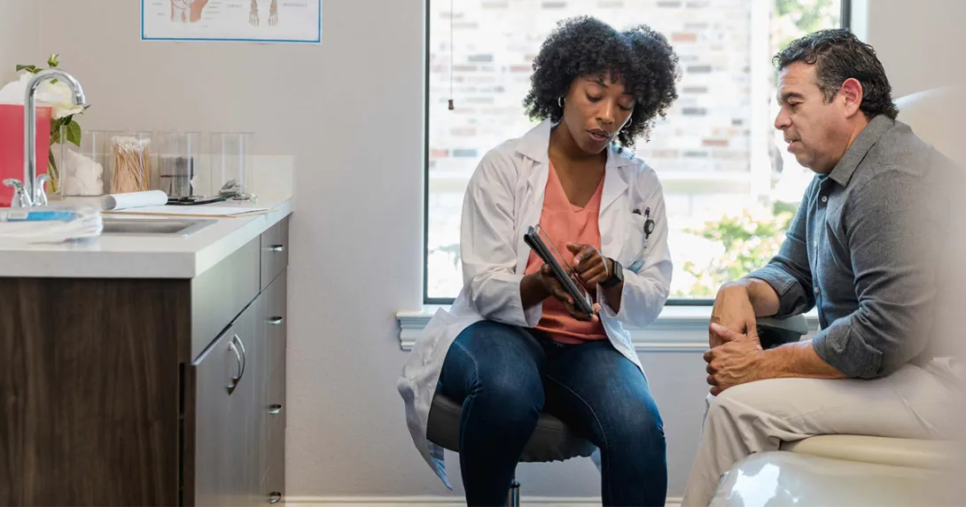 Doctor showing tablet to patient Doctor showing tablet to patient