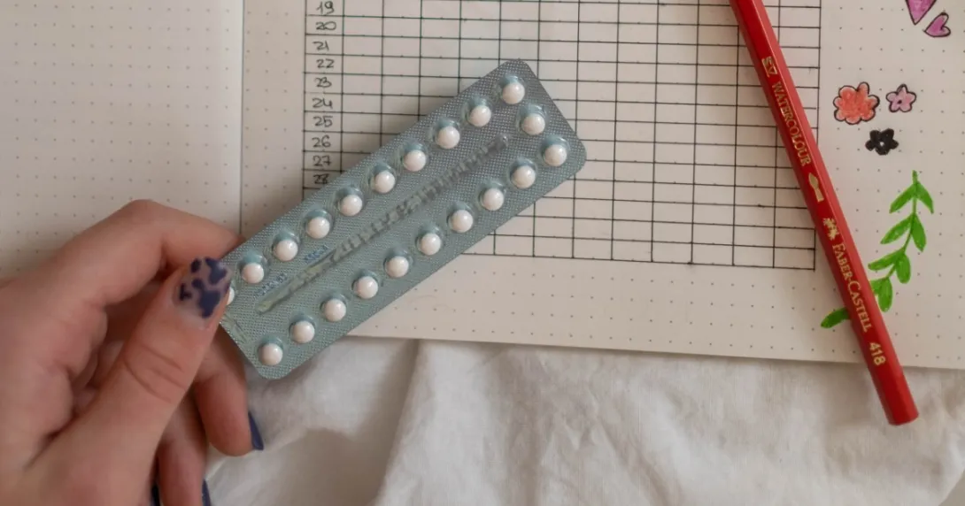 A hand holding birth control