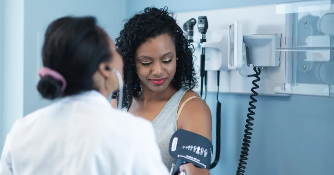 A doctor takes a patient's blood pressure