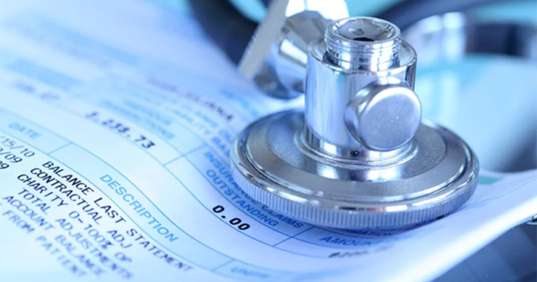 Cancer care bill and stethoscope Cancer care bill and stethoscope