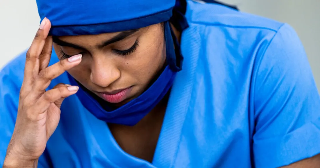 A stressed-out person in scrubs
