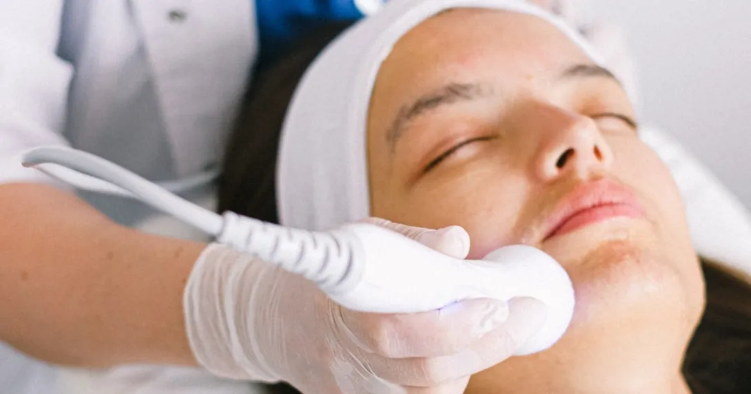 A dermatologist uses a device on a patient
