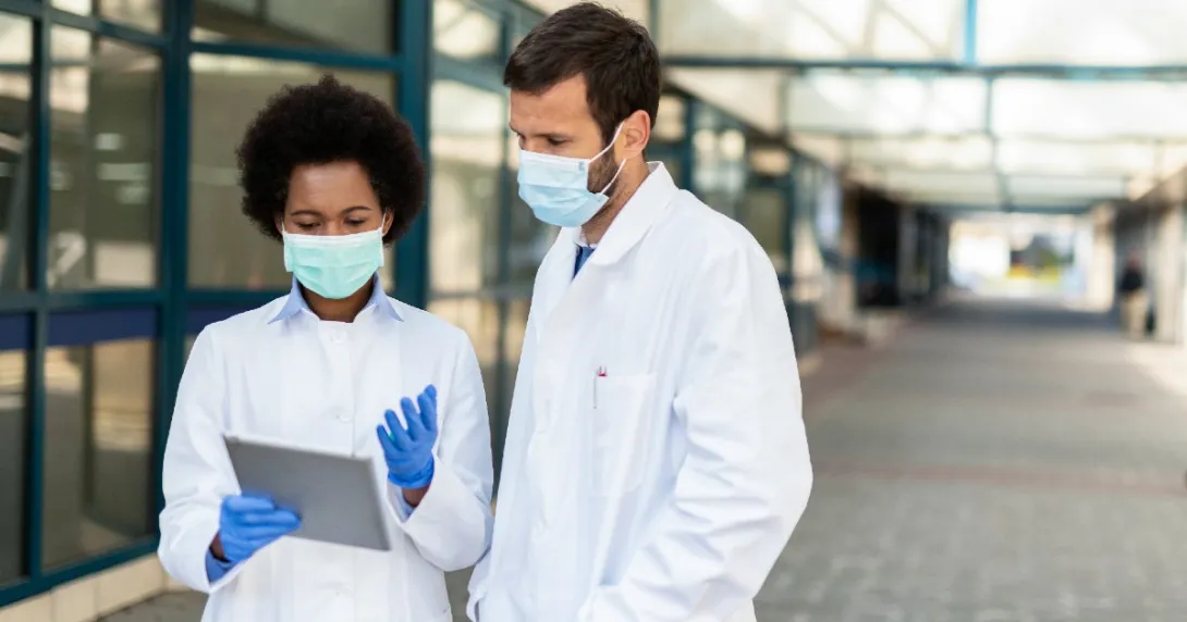 Two doctors looking at an EHR on a tablet