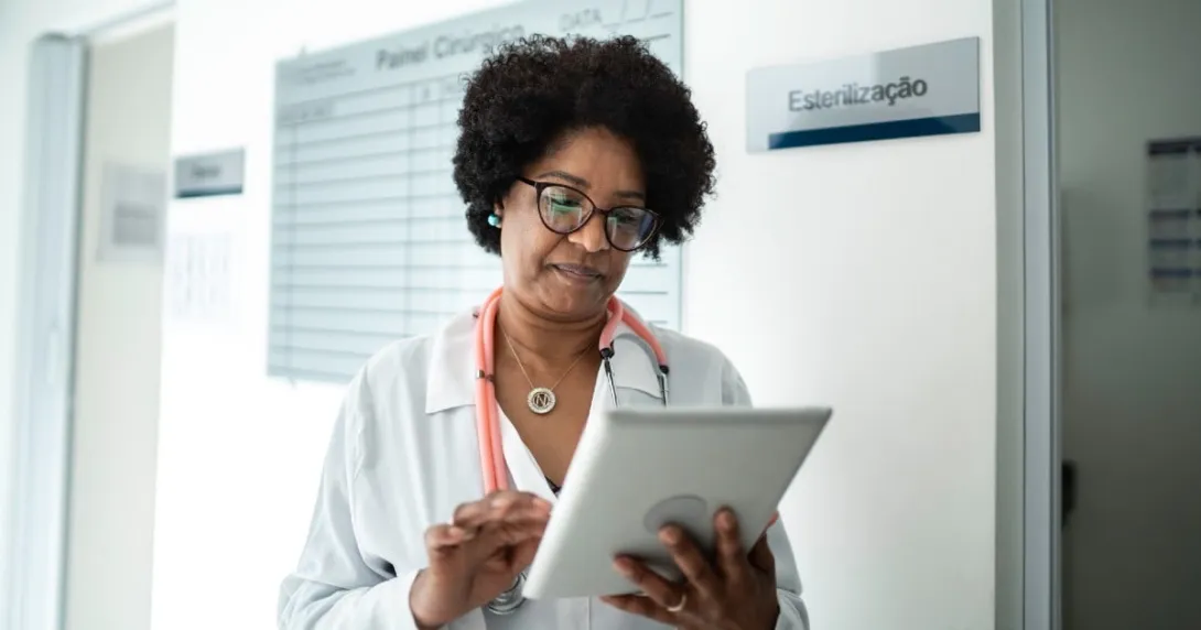A doctor looking at a tablet