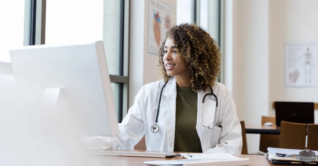 A doctor on a computer looking at a patient's electronic health record