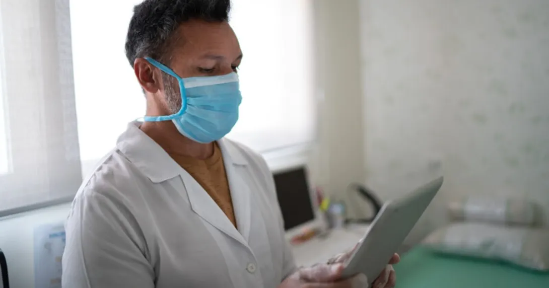 A doctor speaking with a patient via tablet